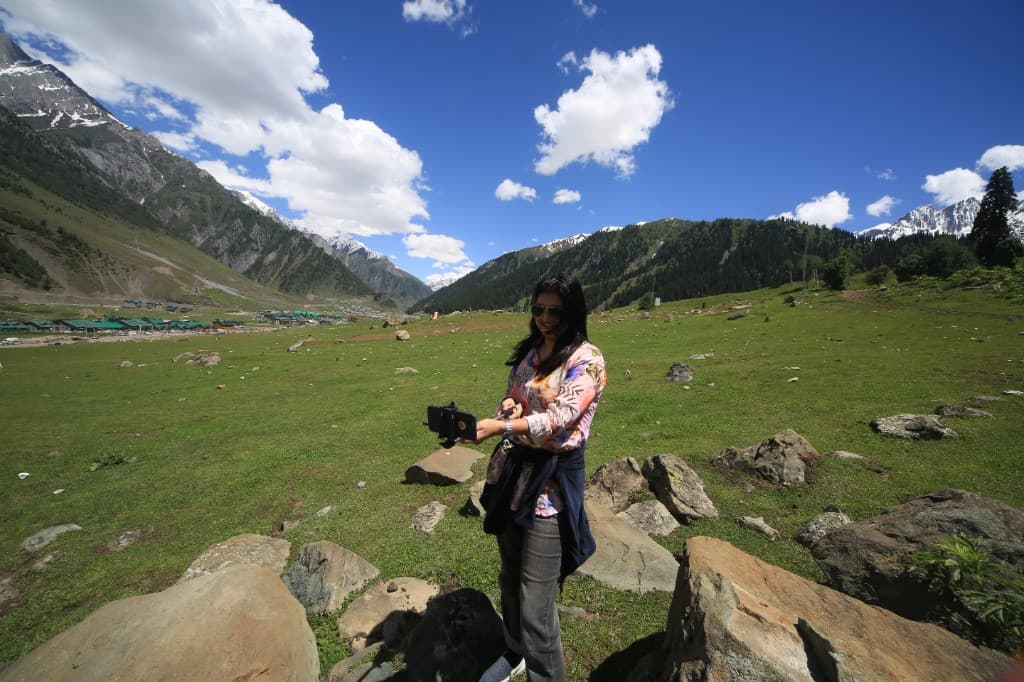 Gurmeet photographing in a mountain valley